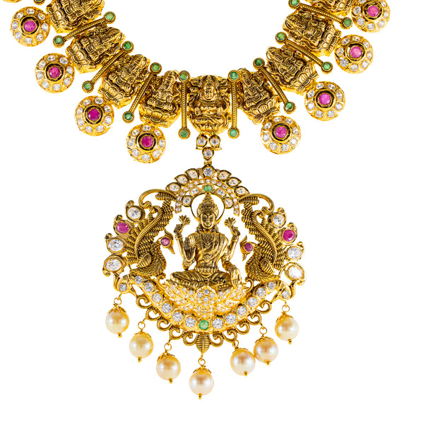 22K Antique Gold Lakshmi Necklace w/ CZ, Emerald, Ruby & Pearl (111.7gm) | 



Designed with the elegance, this 22k antique gold Lakshmi necklace set by Virani Jewelers fea...