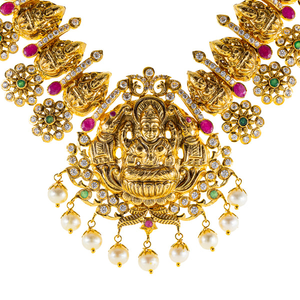 22K Antique Gold Temple Necklace w/ CZ, Emerald, Ruby & Pearl (88.3gm) | 



Virani Jewelers presents to you this stunning 22k antique gold necklace that captures the ess...