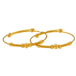 An image of two 22K gold bangles with a textured design from Virani Jewelers.